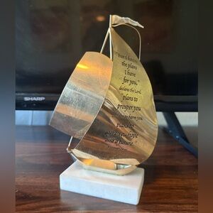 brass sailboat on marble base with Bible sculpture text engraved on its sail.